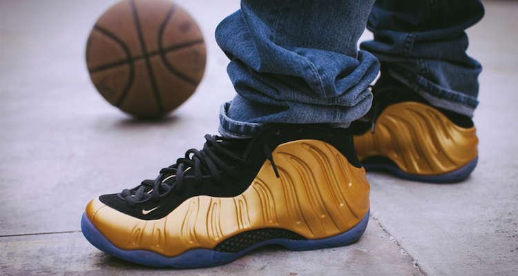 black and gold foams on feet