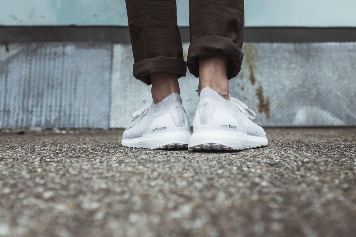ultra boost triple white uncaged on feet