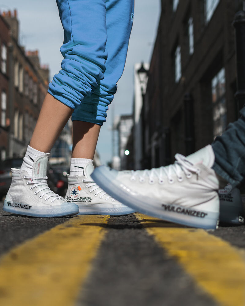 white converse on feet