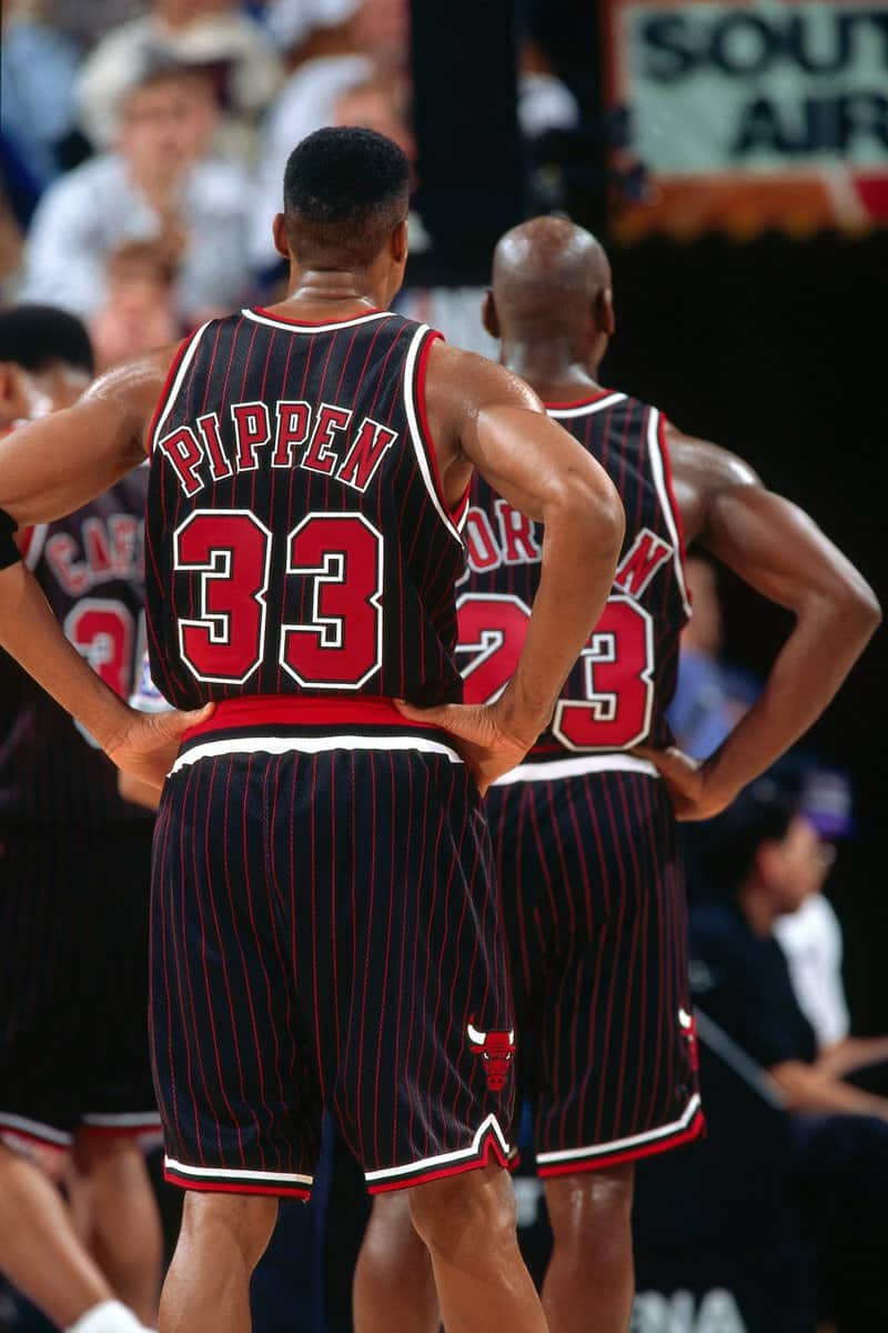 Michael Jordan in the black uniform with red pinstripes introduced